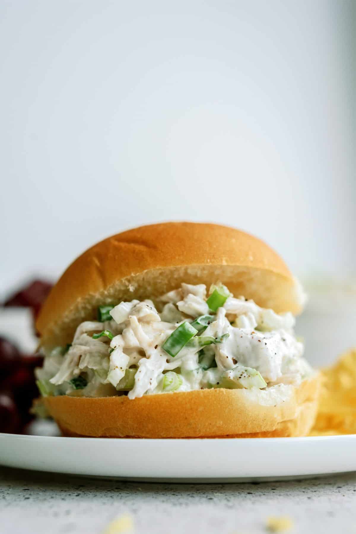 Kneaders Copycat Chicken Salad in a bun on a plate