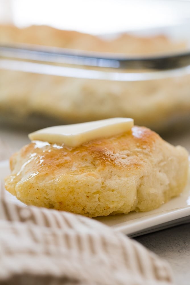 Easy 7 Up Biscuits on a plate with a pad of butter on top