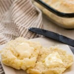 7 Up Biscuit on a plate with squares of butter on top of each half.