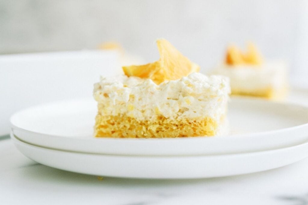 Side view of a slice of Pineapple Orange Cake on a plate.