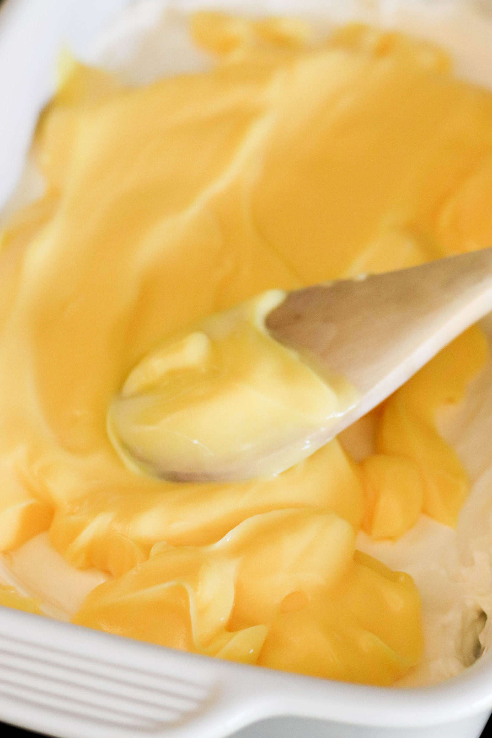 banana cream pudding layer spread over top the cool whip layer with a wooden spoon.