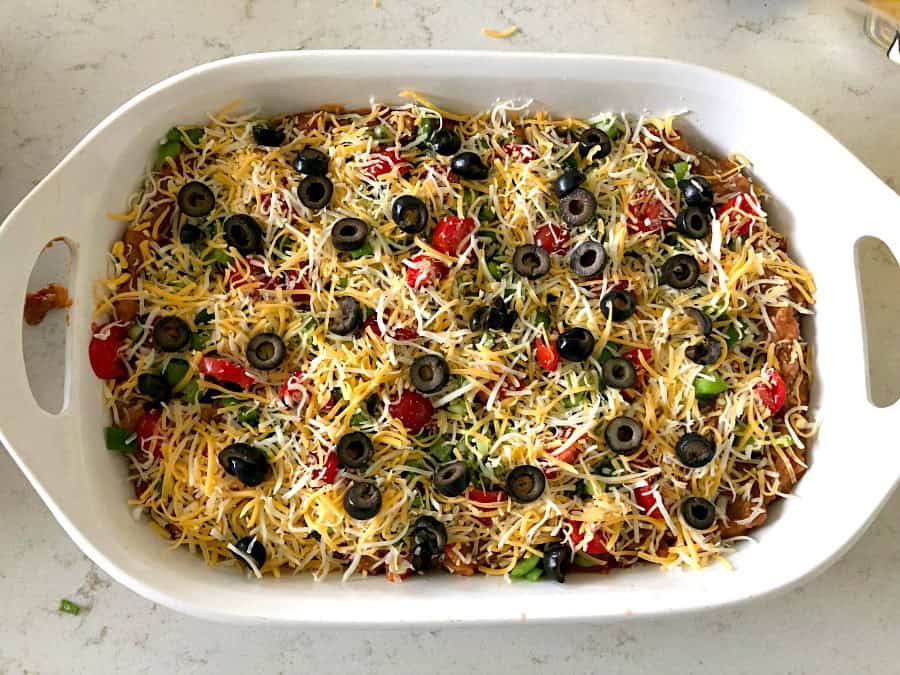 Unbaked Beef and Bean Taco Casserole in white casserole dish