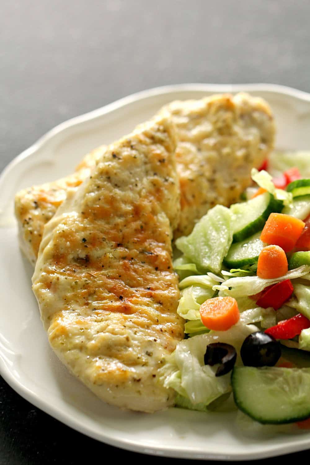 Parmesan Chicken Bake on a plate with salad