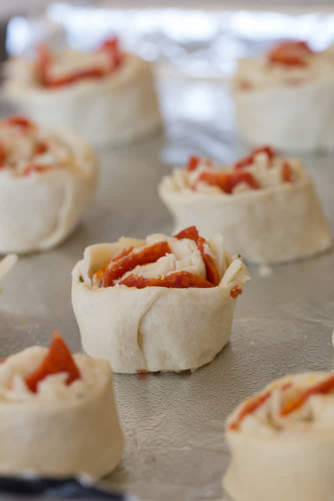 Unbaked Pepperoni Pizza Rolls on a baking sheet