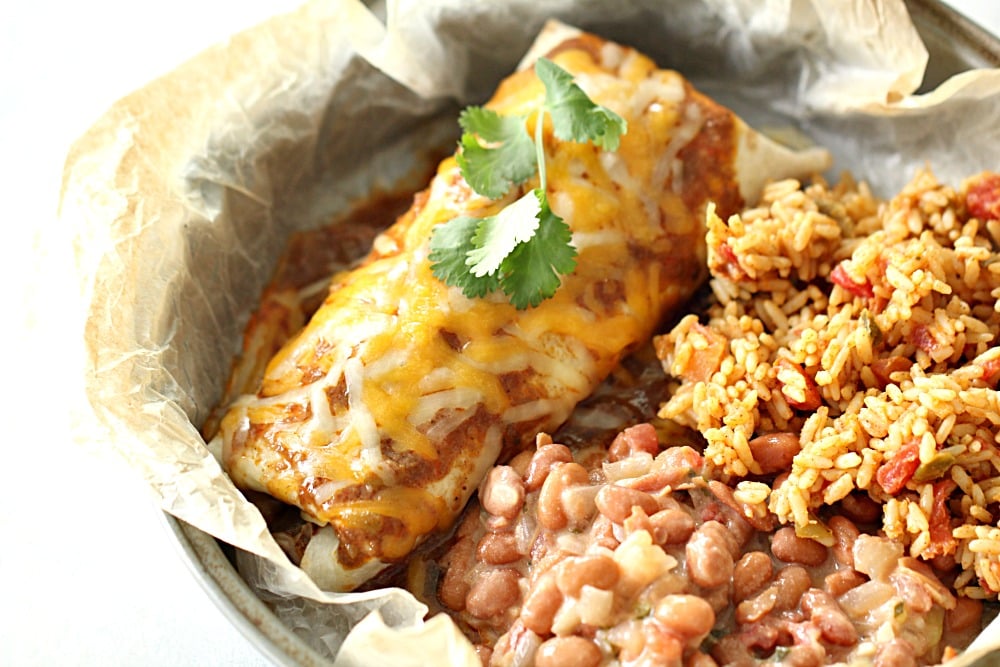 Slow Cooker Chile Colorado Beef Burritos with a side of rice and beans