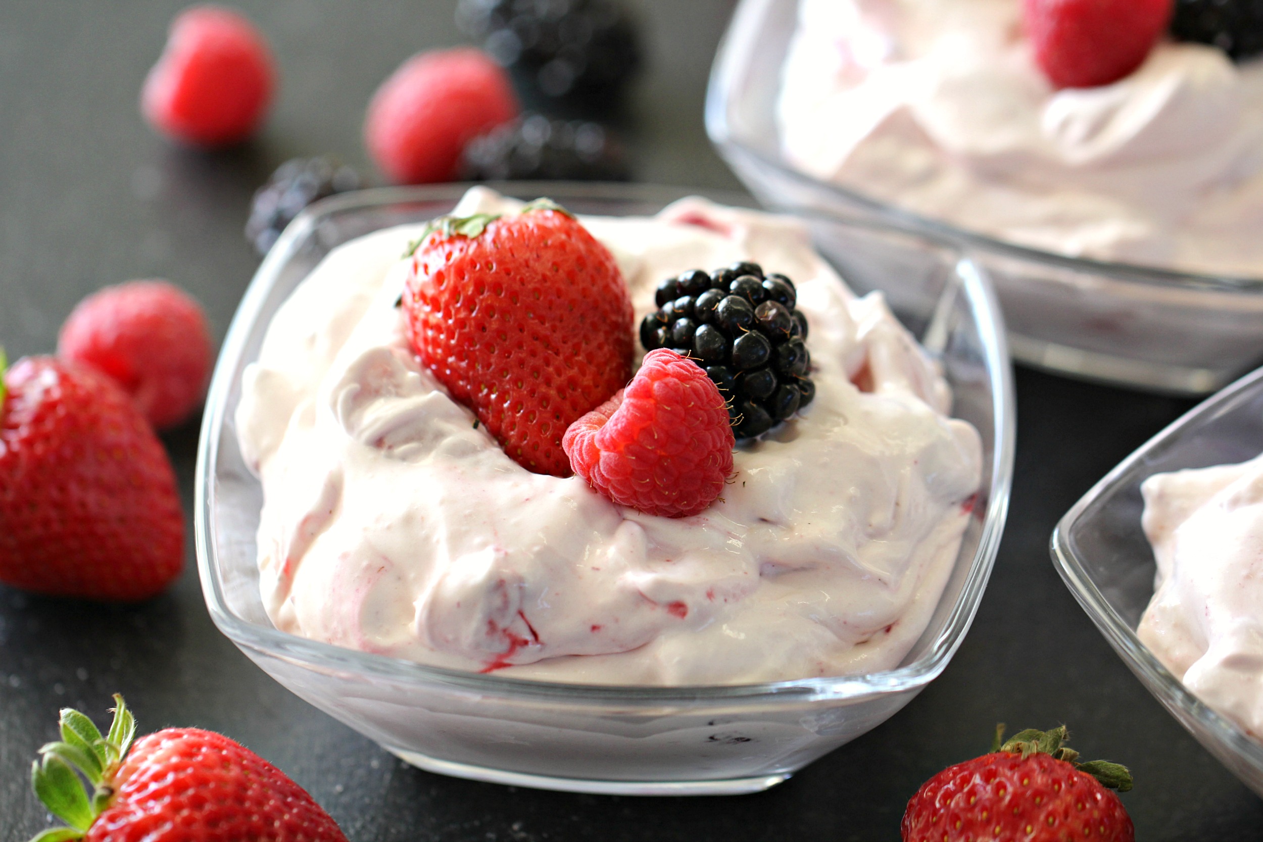 Berry Cheesecake Pudding Salad in individual serving cups with fresh berries