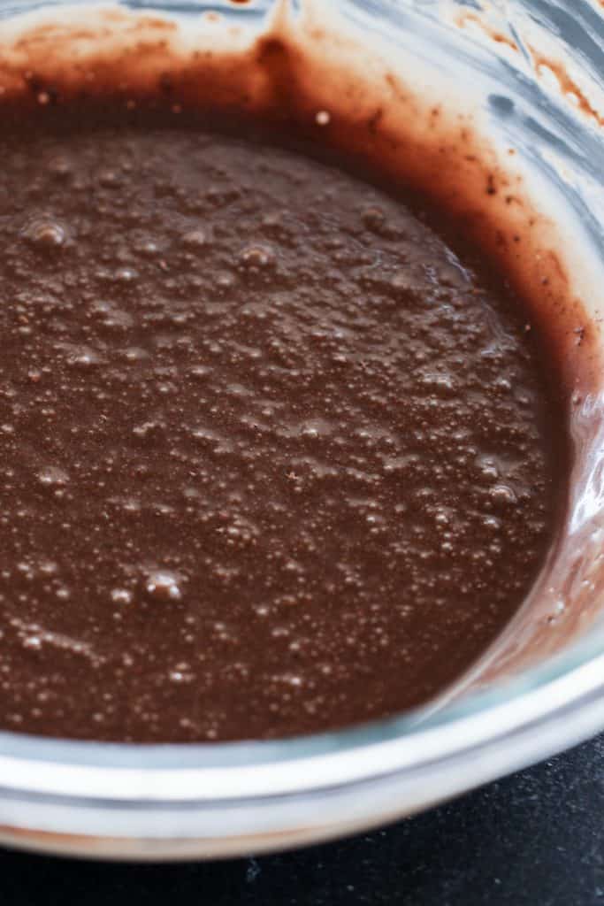 Fudgy Brownie batter in a glass mixing bowl.