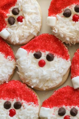 Sugar cookies decorated like Santa grouped together.