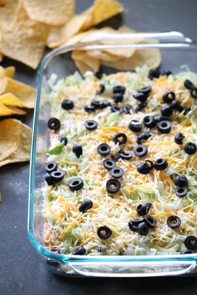 Skinny Taco Dip in a baking dish with chips on the side.