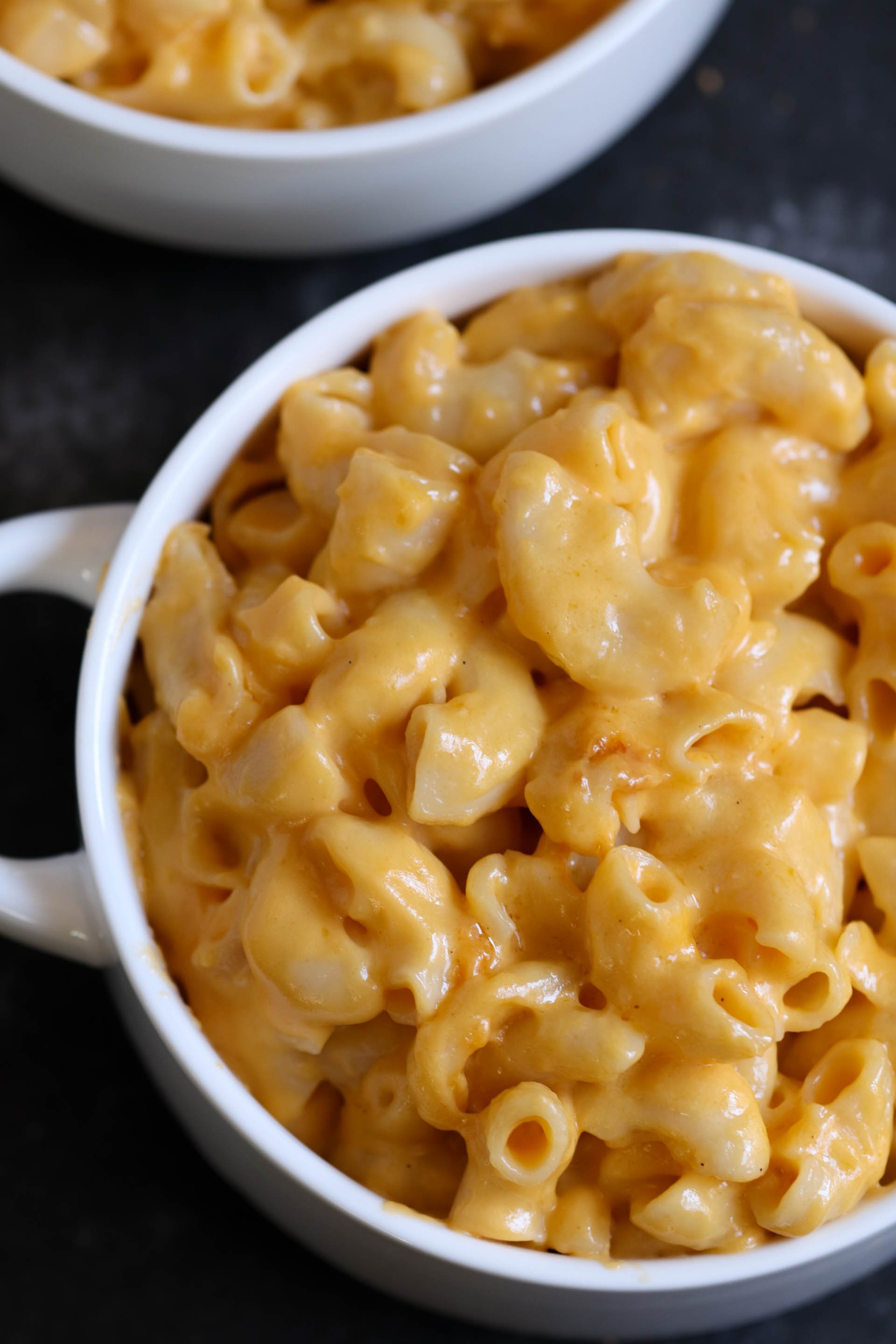 two bowls of cheesy macaroni and cheese