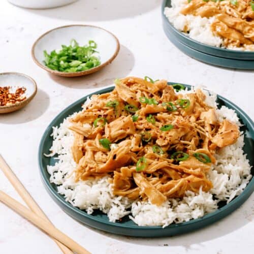slow cooker bourbon chicken on a plate with rice