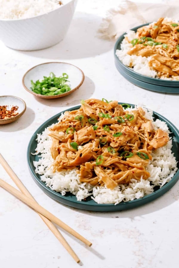 slow cooker bourbon chicken on a plate with rice