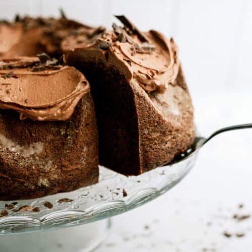 A spatula lifting a slice of Triple Chocolate Bundt Cake away from the cake.