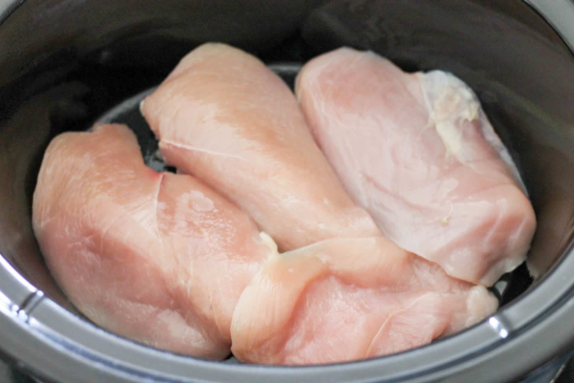 Raw chicken breast in the slow cooker