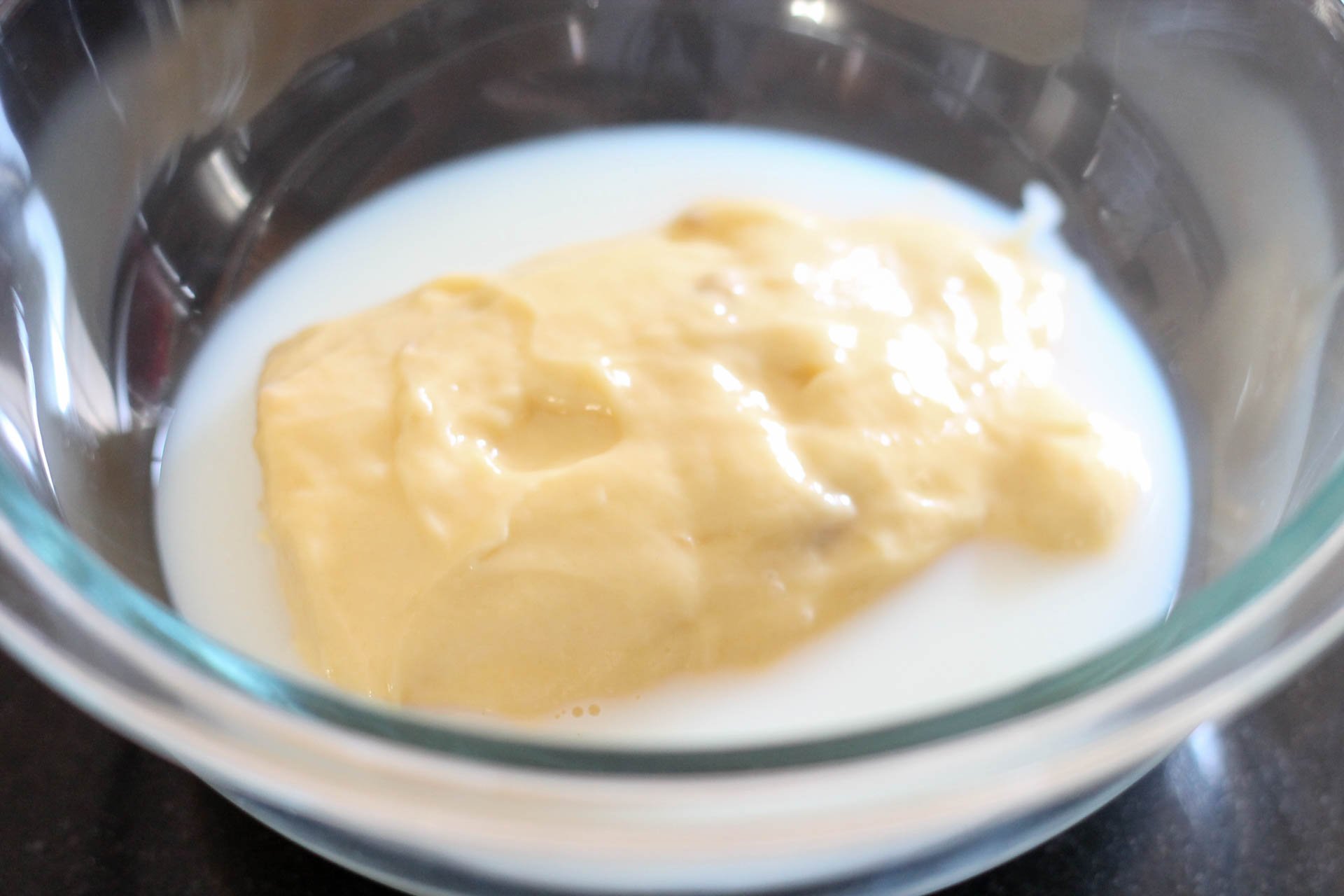 cream of chicken soup and milk in a glass bowl