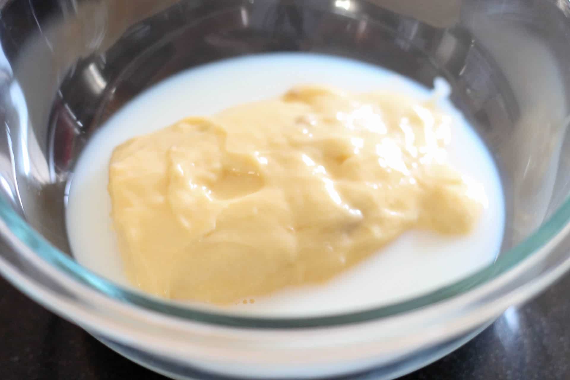 cream of chicken soup and milk in a glass bowl