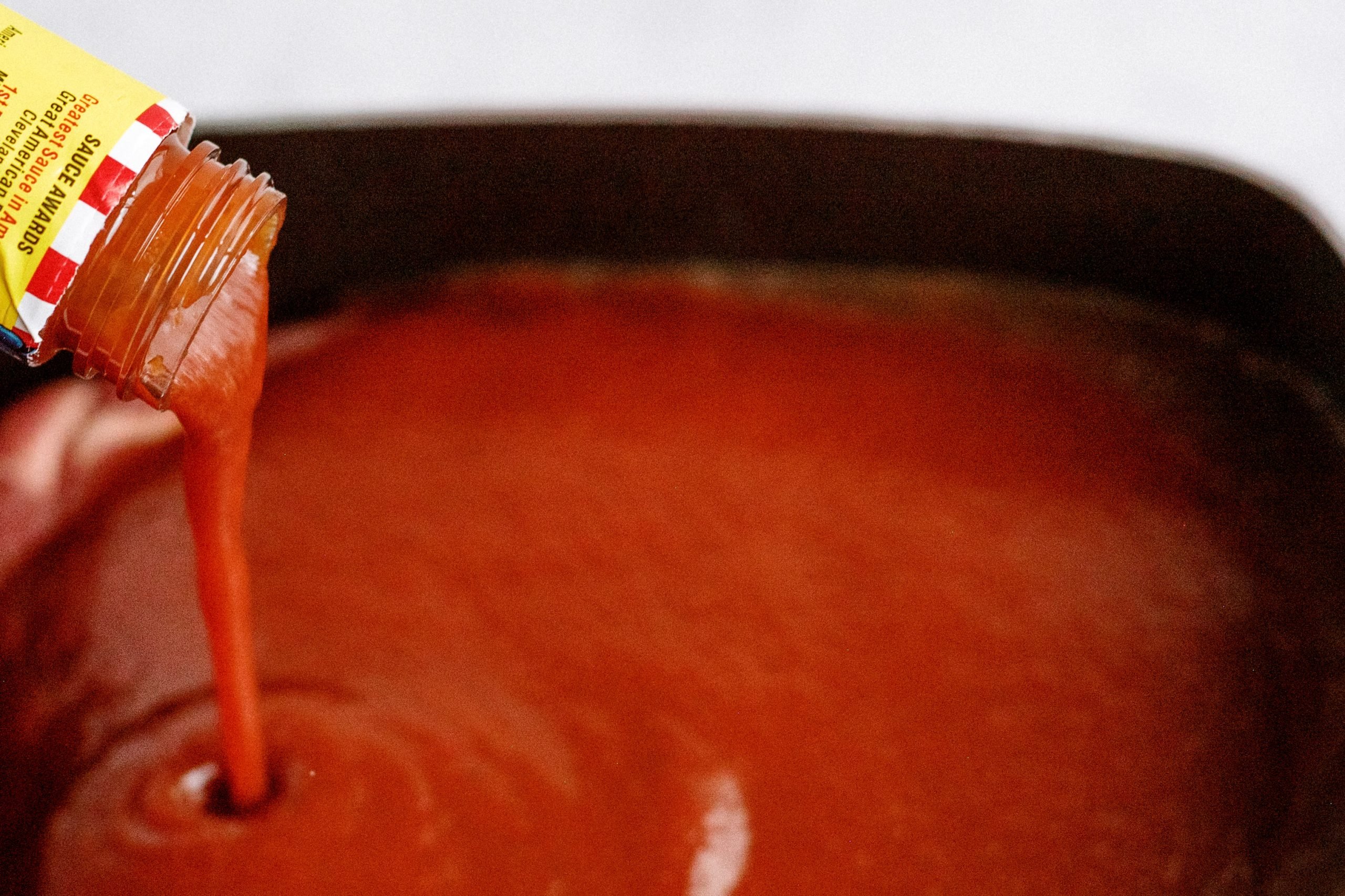Adding a bottle of BBQ sauce into slow cooker