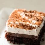 A slice of Chocolate Pudding Cake on a white plate.