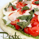 homemade pizza - fresh pesto pizza with tomatoes and basil
