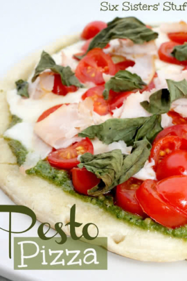 homemade pizza - fresh pesto pizza with tomatoes and basil