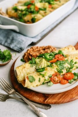 slow cooker chile verde pork enchilladas on a plate