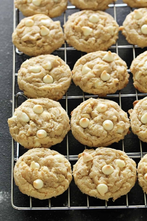 White Chocolate Chip Oatmeal Cookies line up on a cooling rack.