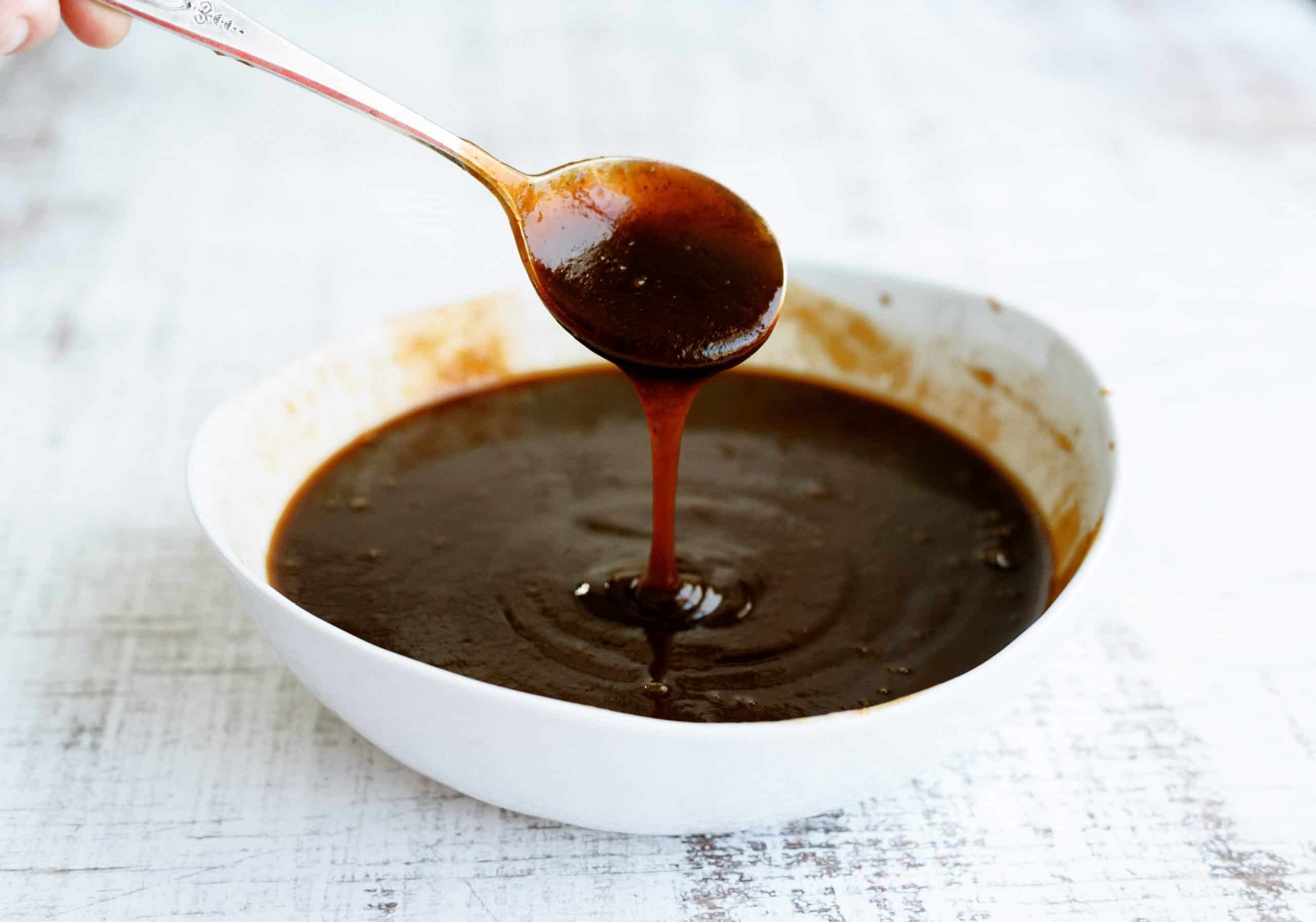 BBQ sauce in a bowl with a spoon