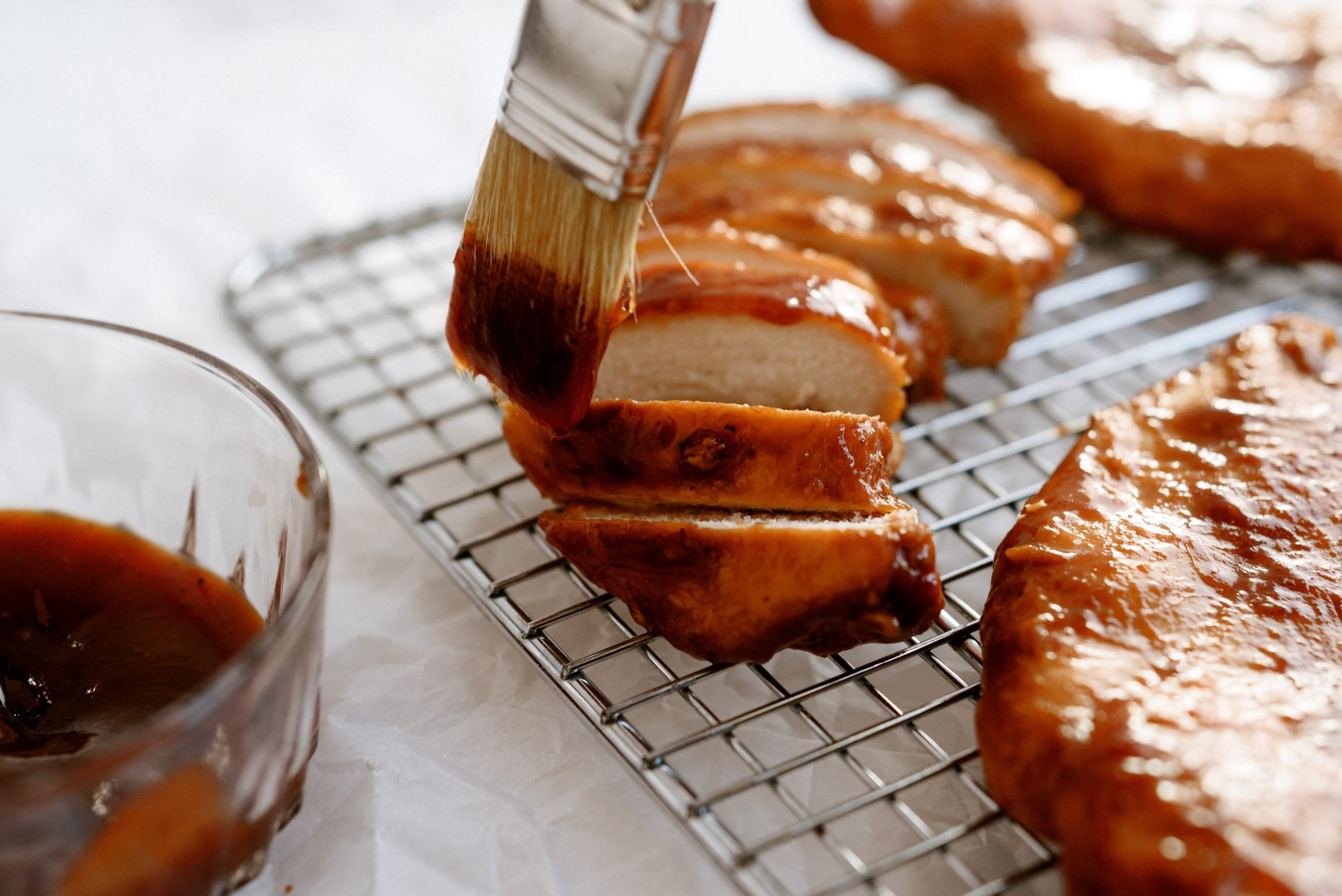 Basting chicken with extra BBQ sauce