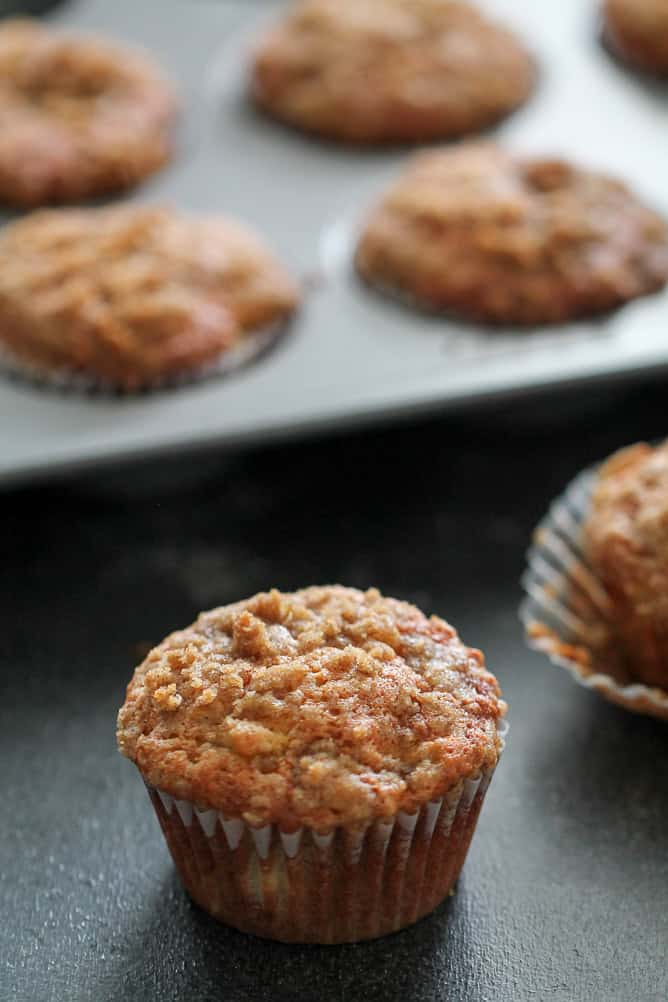 Banana Crumb muffins on the counter and some in the tin.