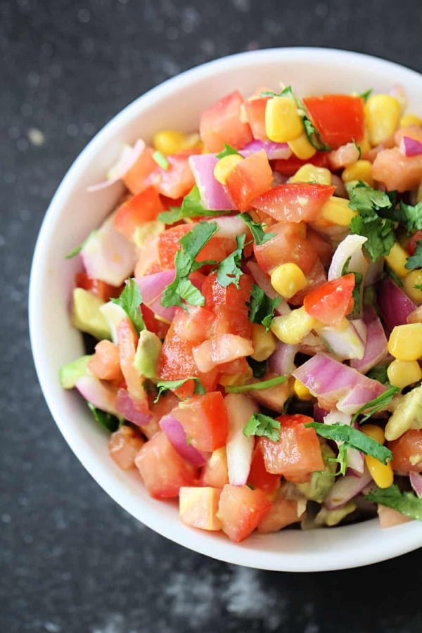 A white bowl filled with Fresh Lime Salsa.
