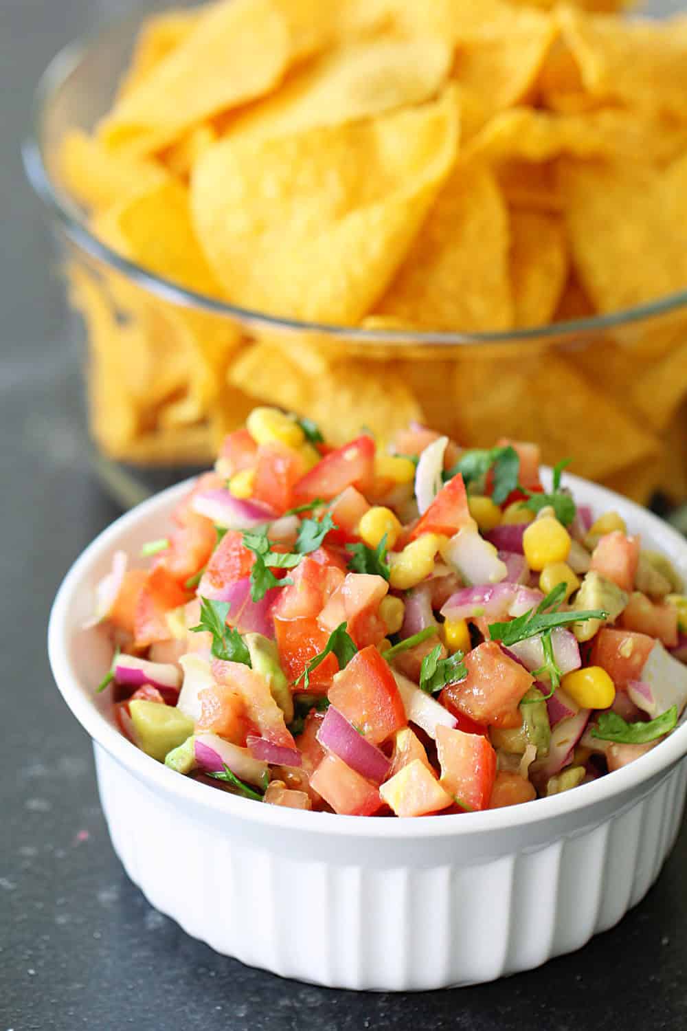 Fresh lime salsa in a white dish with chips