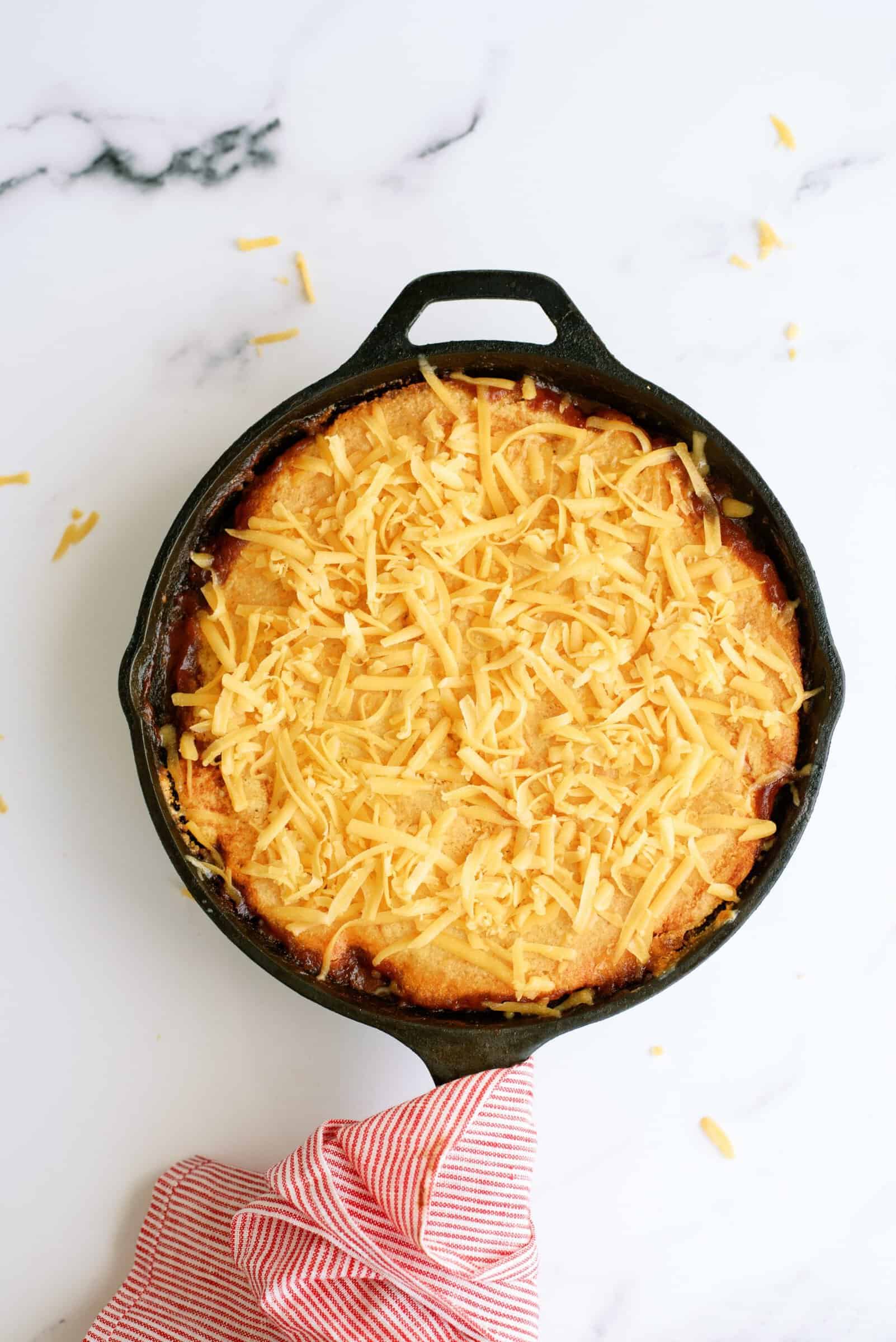 Shredded cheese on top of Cornbread Sloppy Joe Casserole