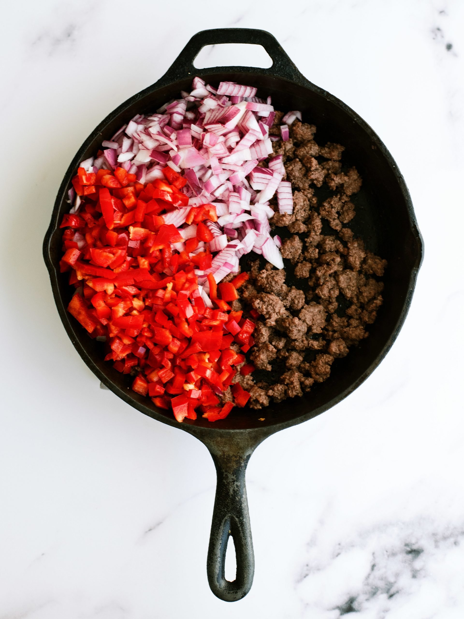 Ground beef, onions and peppers in skillet