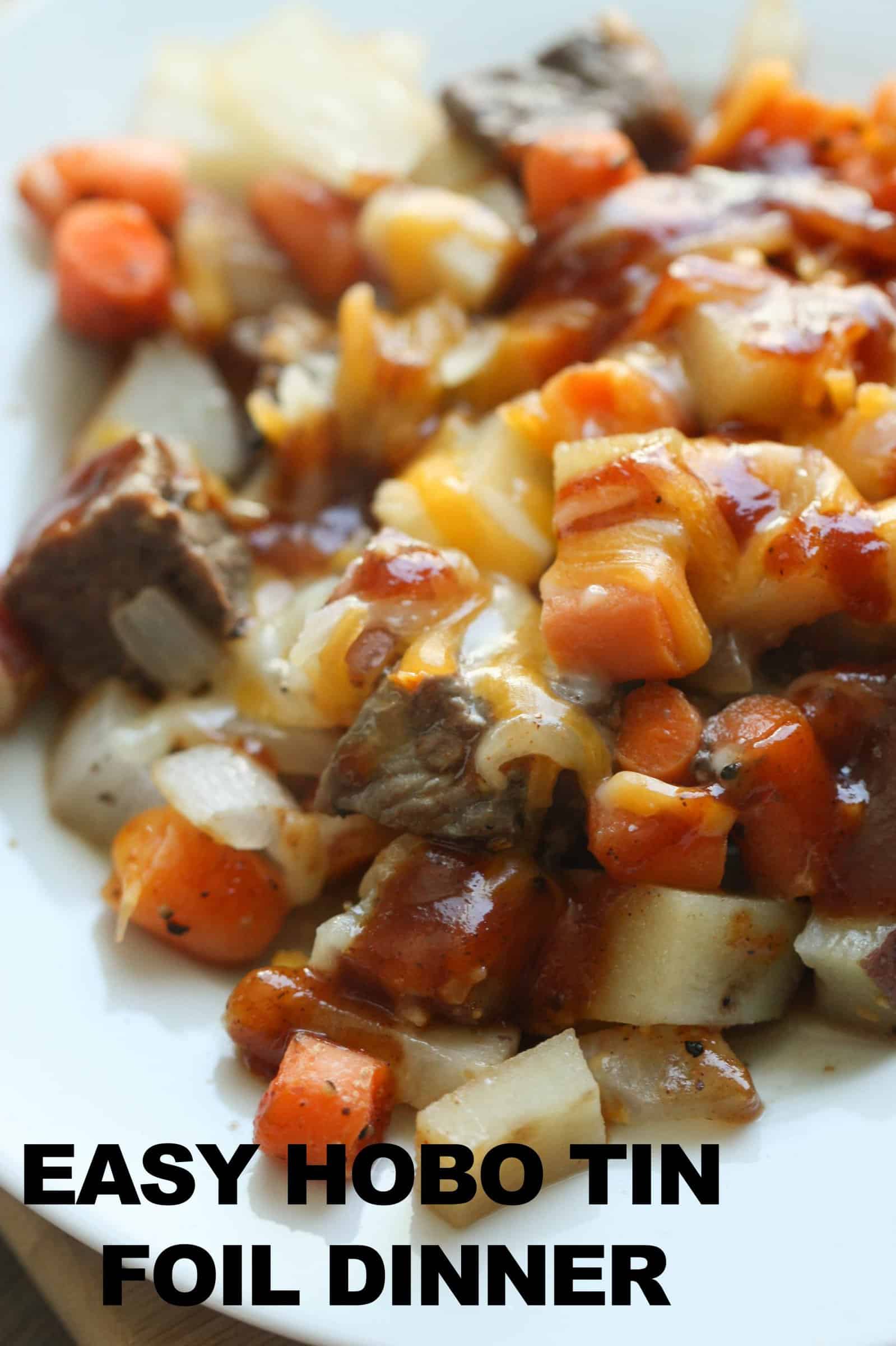 Cooked beef, carrots, potatoes and onions on a piece of foil
