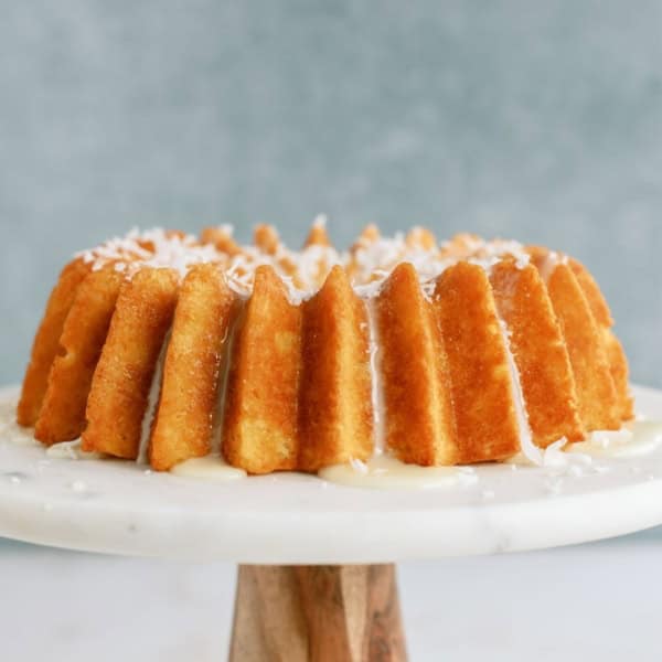 Pineapple Coconut Bundt Cake on a cake stand.