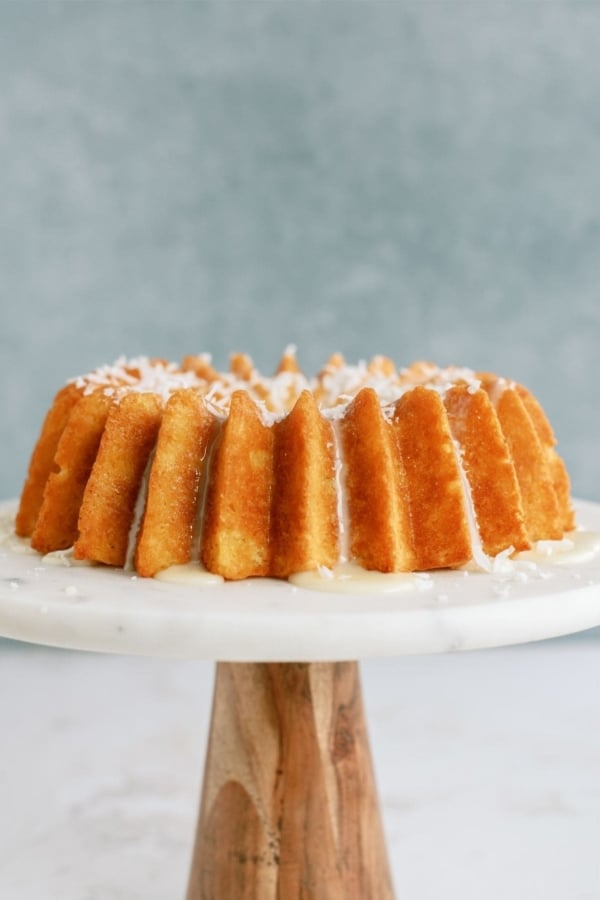 Pineapple Coconut Bundt Cake on a cake stand.