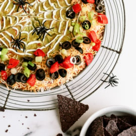 Spooky 7-layer dip served with tortilla chips