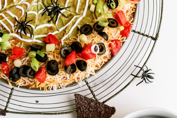 Spooky 7-layer dip served with tortilla chips