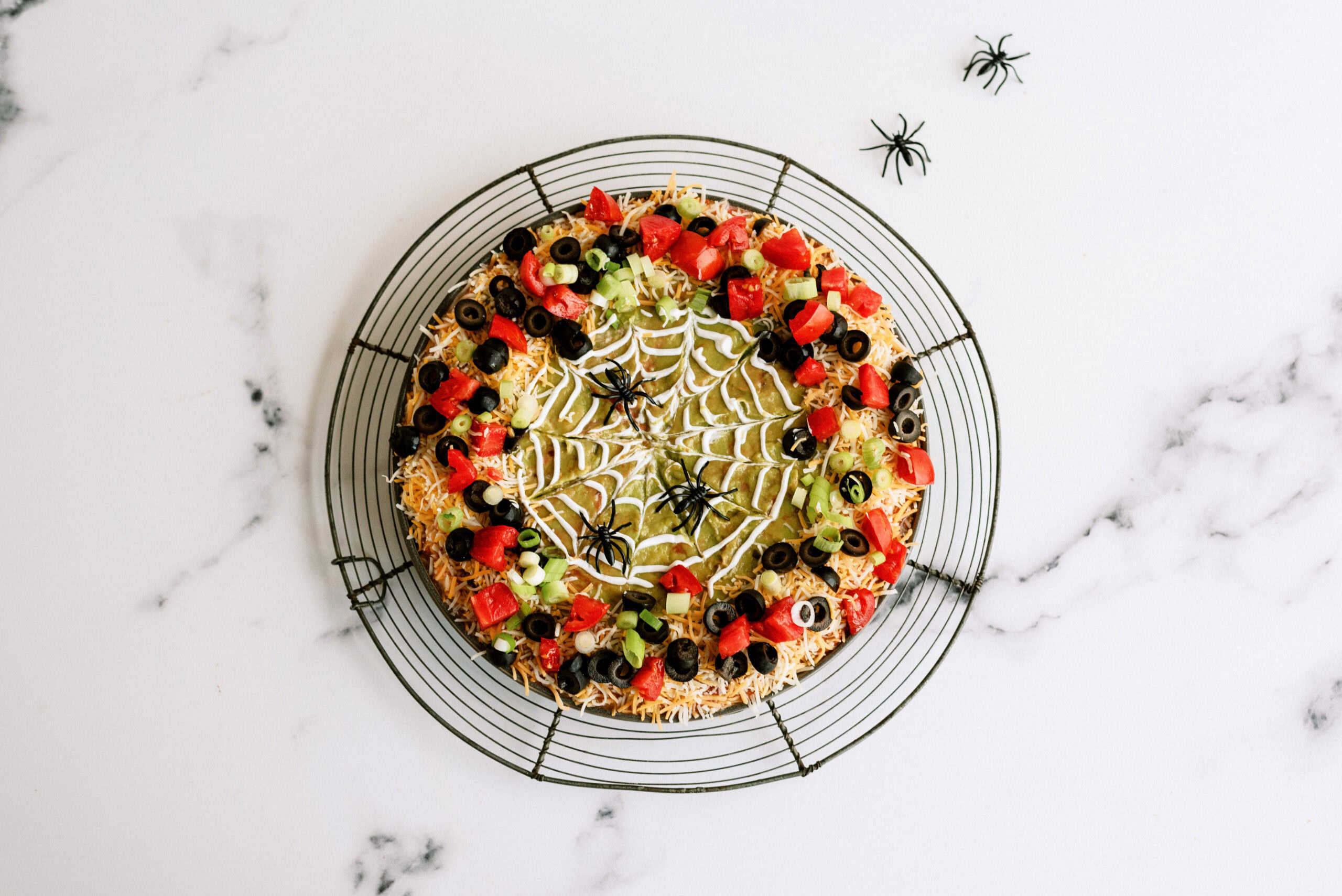 Finished spooky 7-layer dip with fake spiders