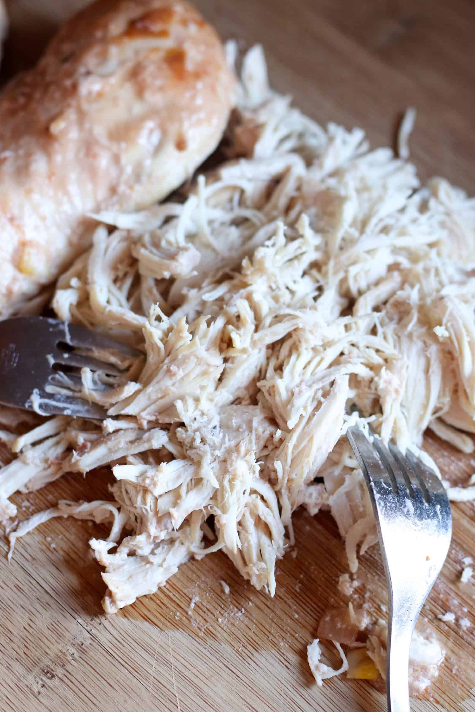 Shredding chicken breast on a cutting board