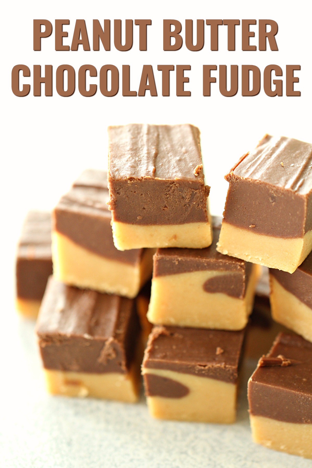 Sliced chocolate peanut butter fudge stacked for serving