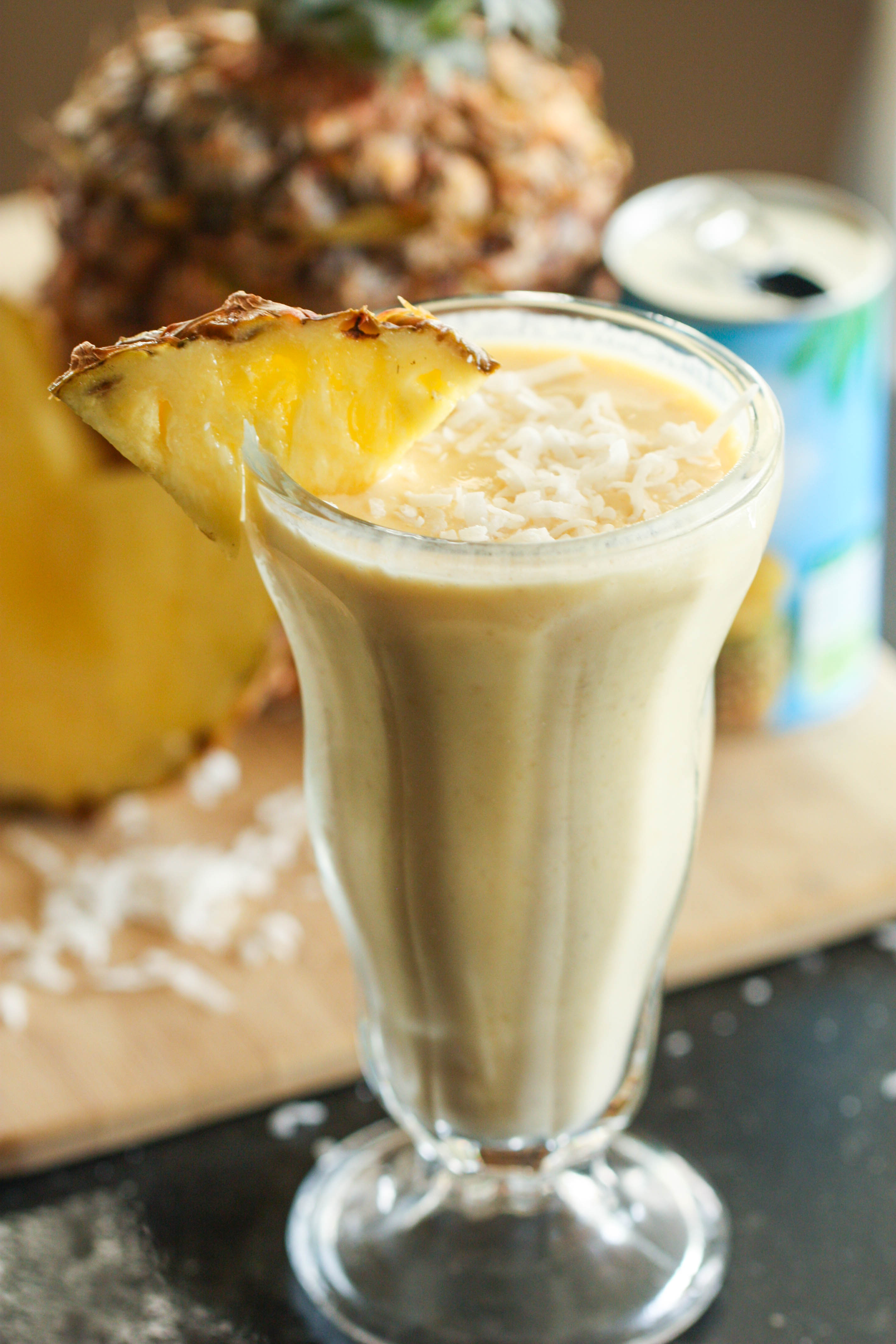 Piña Colada Fruit Smoothie in a tall glass garnished with pineapple