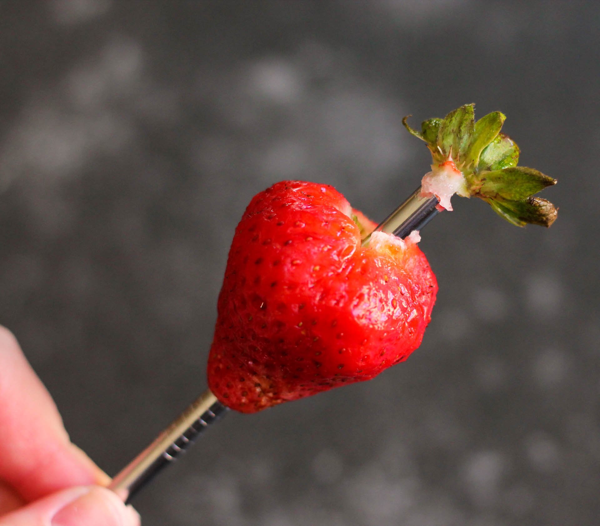 Strawberry on a metal straw