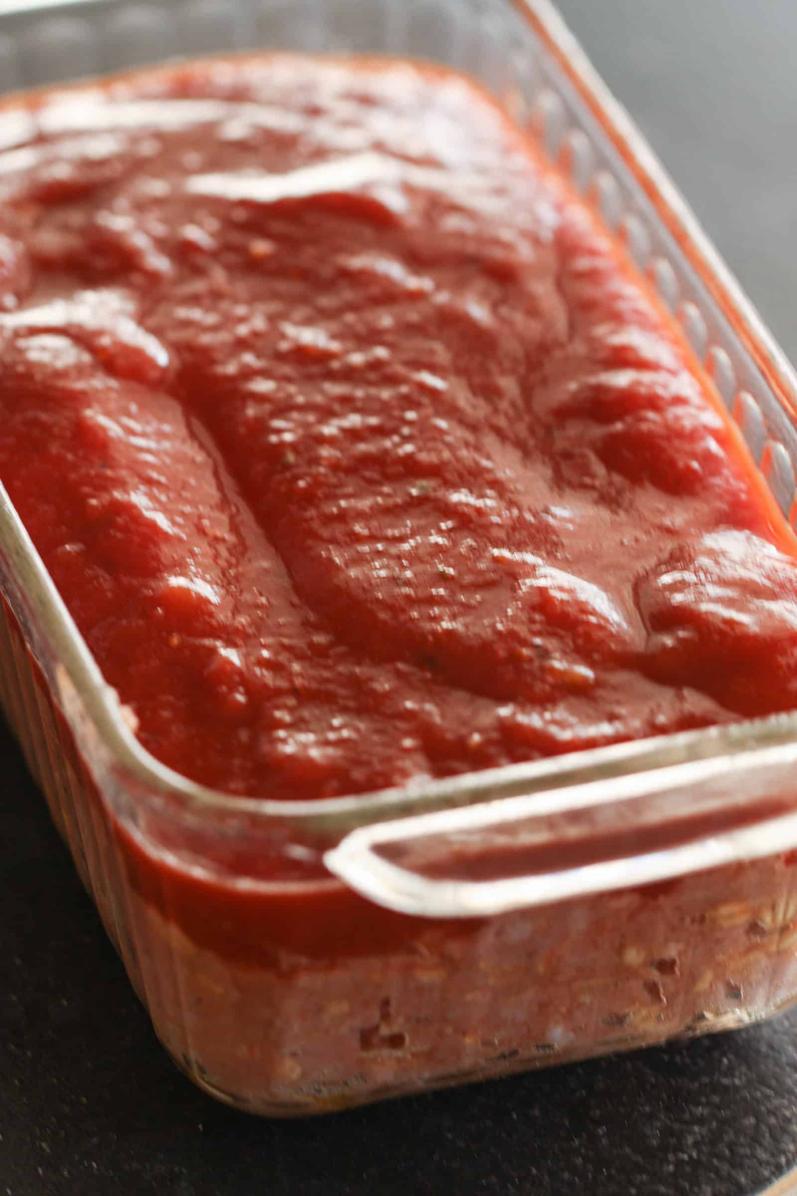 Sauce on top of uncooked  meatloaf