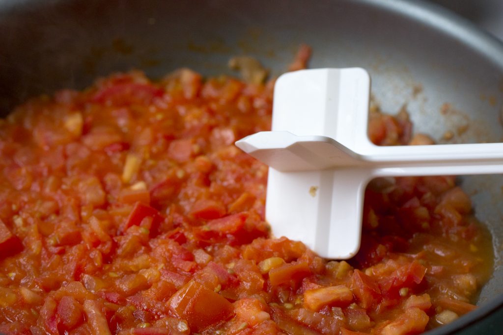 Mashed tomatoes in pan