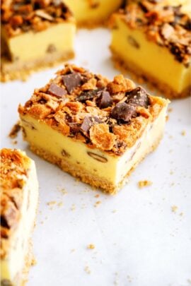 Butterfinger Ice Cream Bars cut into squares topped with crushed butterfingers.