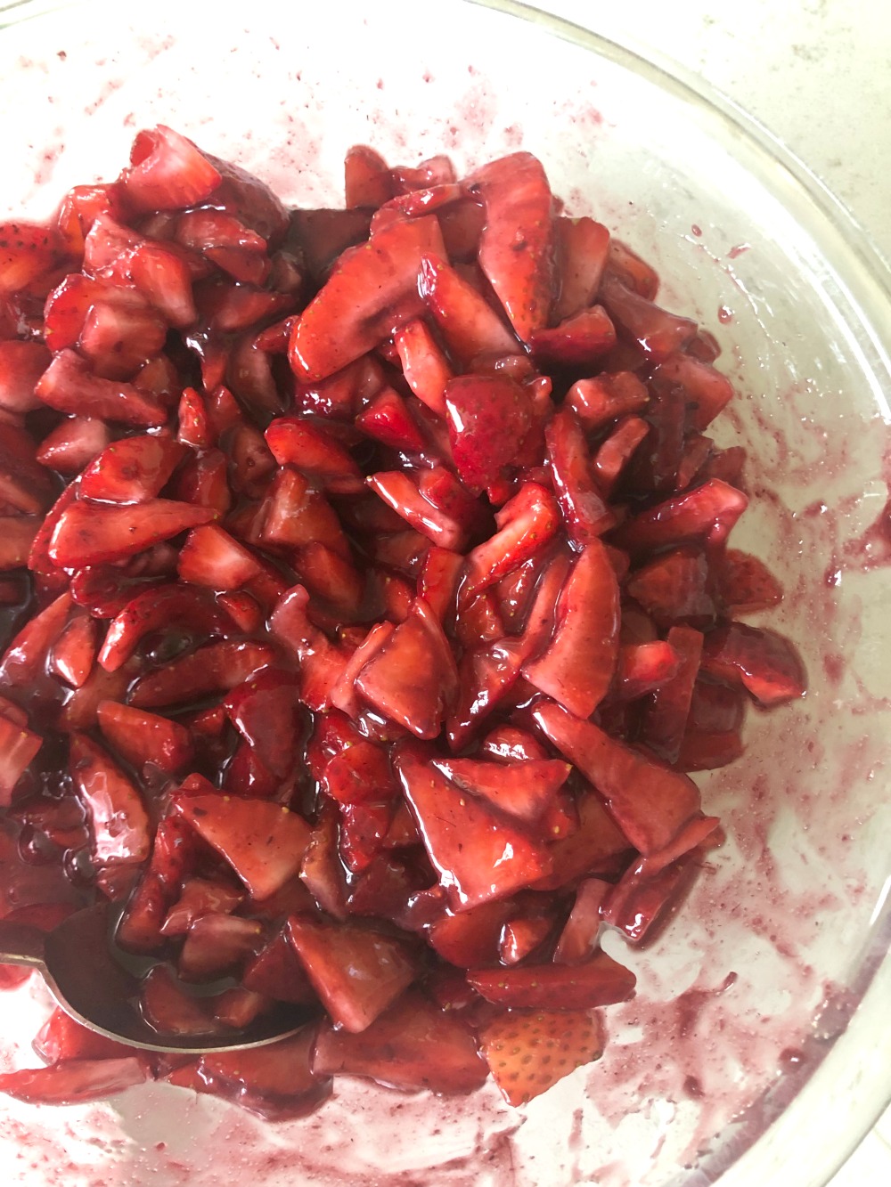 Strawberry mixture in a glass mixing bowl