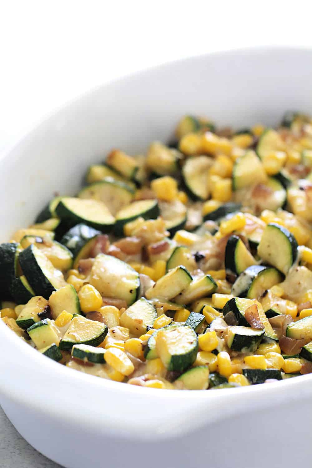 Zucchini Corn Parmesan Bake in a white dish