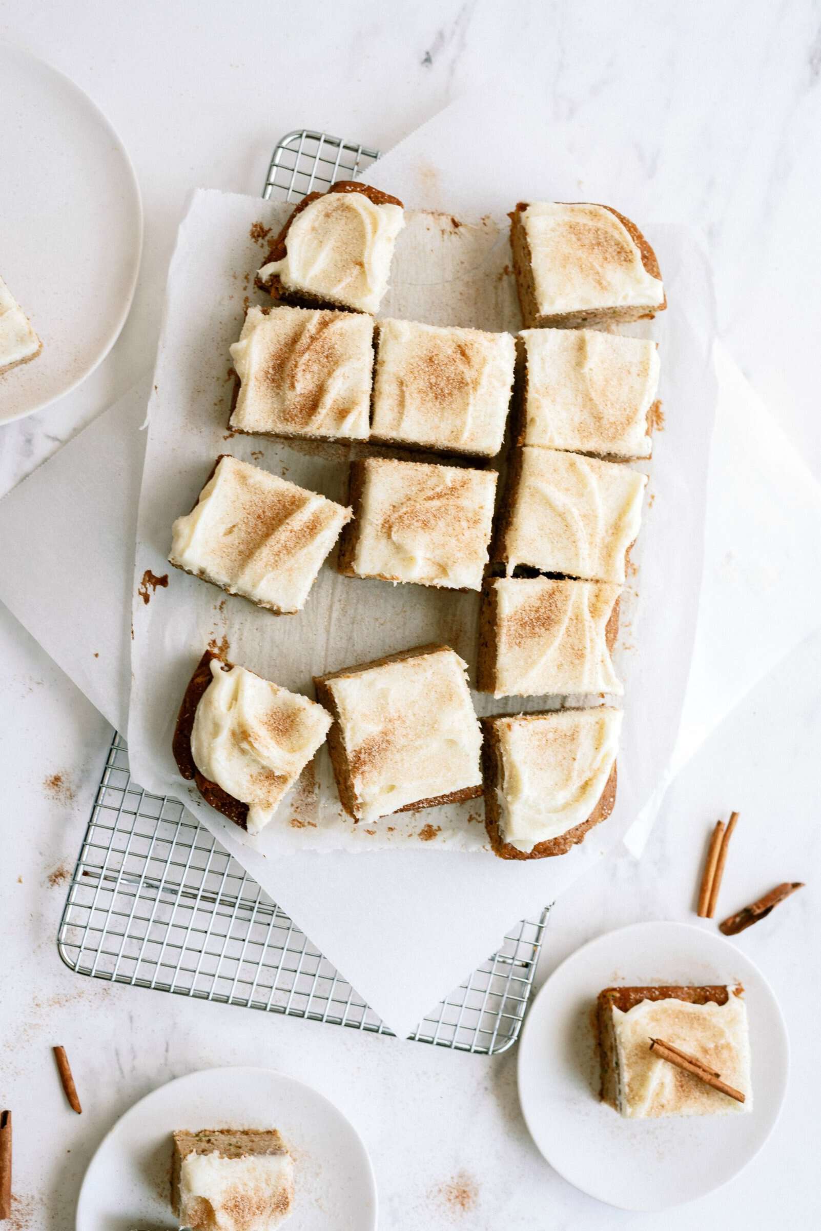 Cinnamon Zucchini Cake with Cream Cheese Frosting sliced into squares.