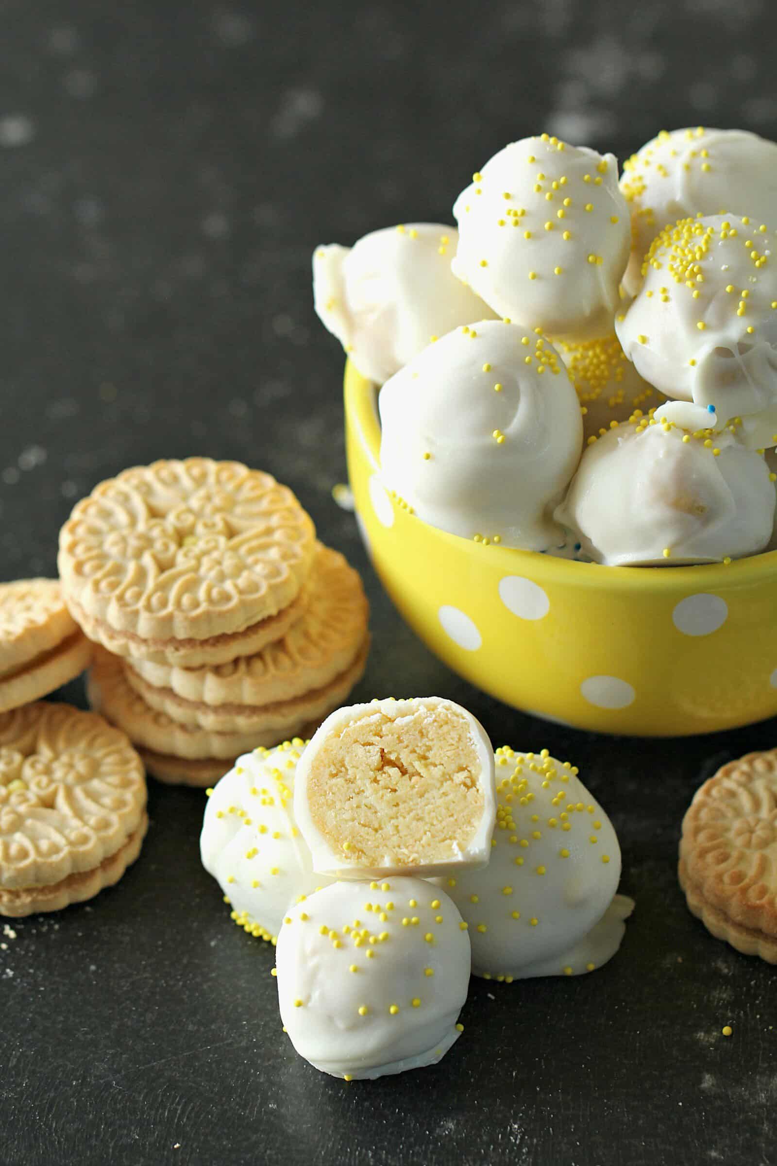 No Bake Lemon Cookie Truffles in a bowl with one cut in half 